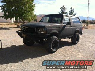 Black Ford Bronco with aftermarket bumper and large tires