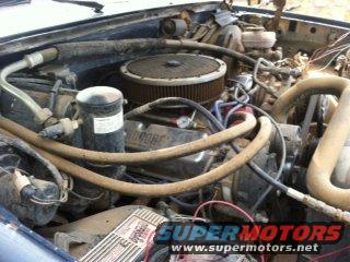 Engine bay with V8 engine, air cleaner, and hoses