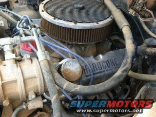 Close-up of a V8 engine with 'HARDCORE' valve covers and an aftermarket air cleaner. Supermotors.net watermark visible