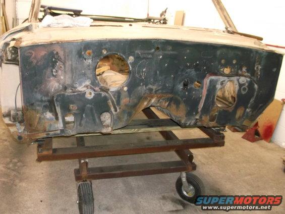 Car firewall assembly on a metal dolly with wheels
