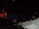 1998 Ford Expedition - A black 1998 Ford Expedition is seen from the side, partially covered in snow during nighttime.