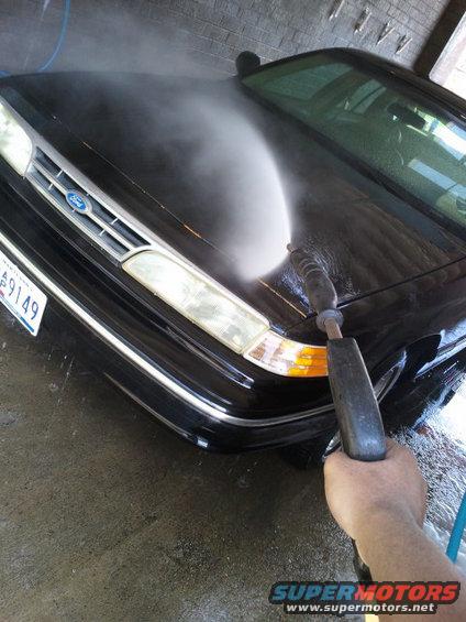 1997 Ford Crown Victoria front end being pressure washed