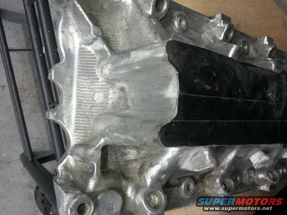 Close-up of an engine intake manifold with black gasket material