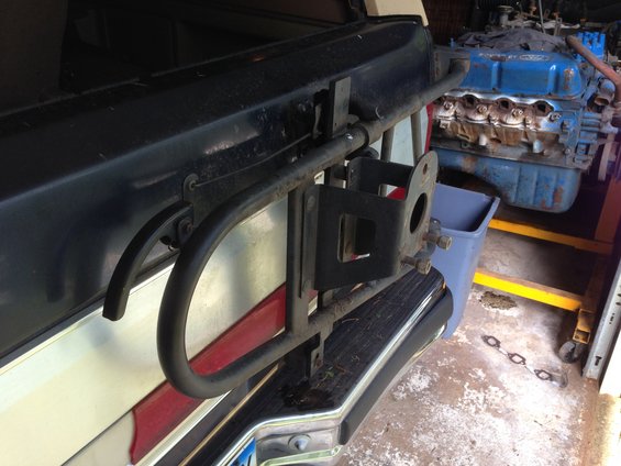 Close-up of a spare tire carrier mount attached to a vehicle's rear bumper
