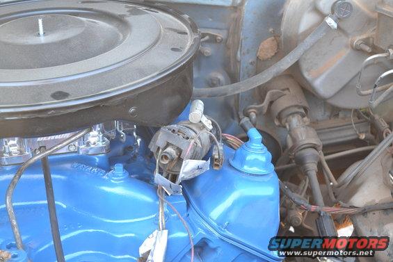 Close-up of a blue painted engine with an air cleaner and distributor