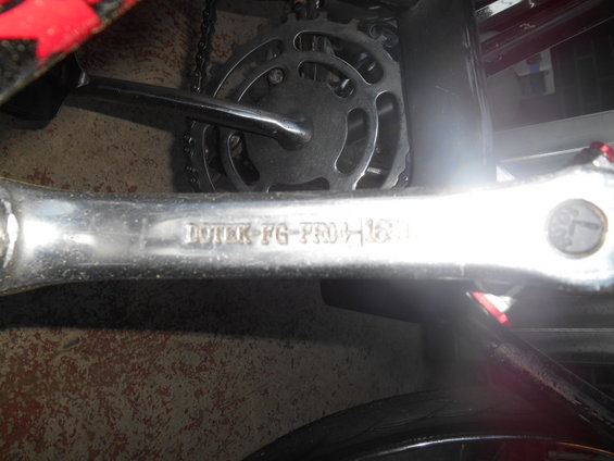 Bicycle crank arm stamped with 'DUTER FG-PRO H161' next to a chainring and chain