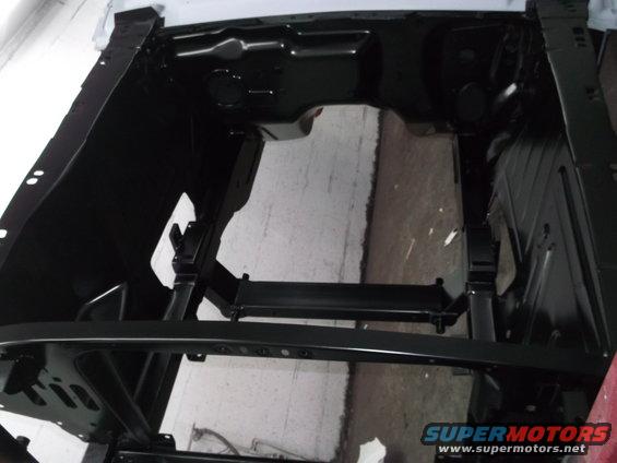 Car frame with black paint, showing engine bay structure and chassis components