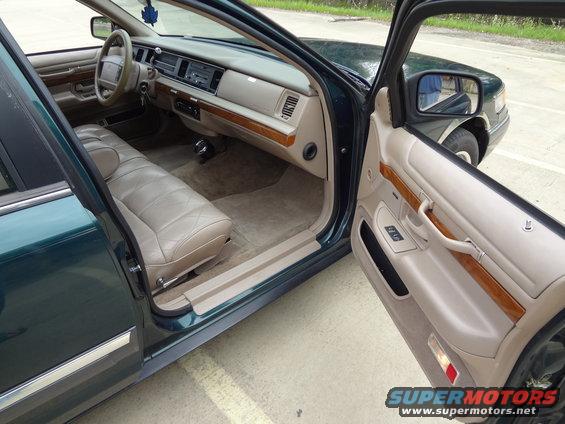 Interior of a 1993 Mercury Grand Marquis with tan leather seats and wood trim