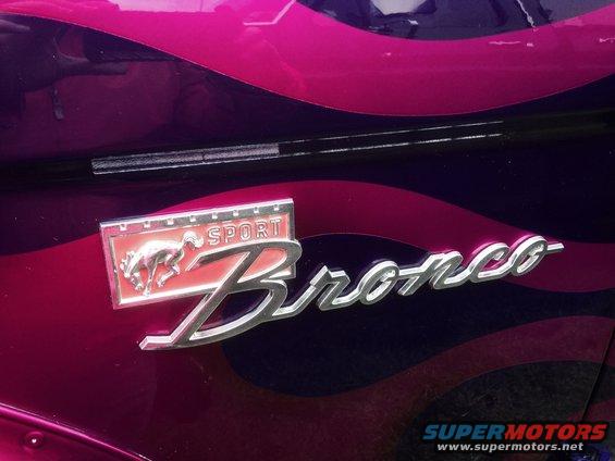 Close-up of a Bronco Sport emblem on a purple and pink wavy paint job