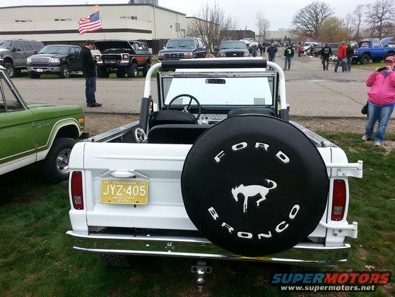 White Ford Bronco rear view, spare tire cover with horse logo, yellow Michigan license plate