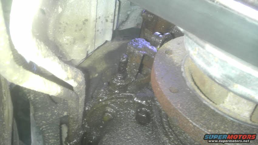 Greasy engine component with metal pipes and a circular flange