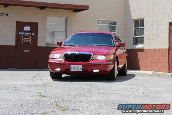 Red 2002 Mercury Grand Marquis front view with custom license plate "EVIL MGM"