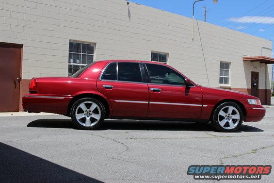 Red 2002 Mercury Grand Marquis parked on asphalt
