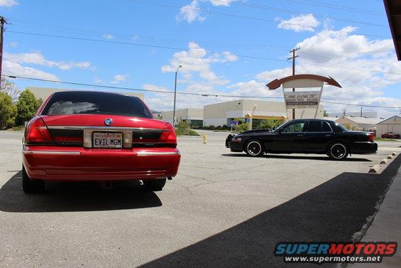 Red 2002 Mercury Grand Marquis rear with custom plate, black 2002 Mercury Grand Marquis side