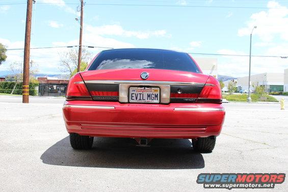 Rear view of a red Mercury Grand Marquis with a California license plate that reads 'EVIL MGM'