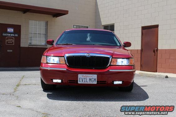 Red 2002 Mercury Grand Marquis front view with custom 'EVIL MGM' license plate