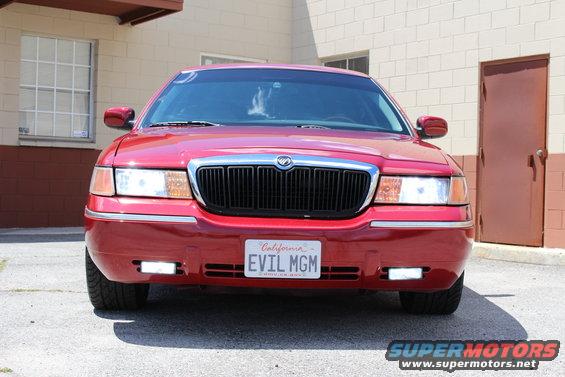 Red 2002 Mercury Grand Marquis with a black grille and "EVIL MGM" California license plate
