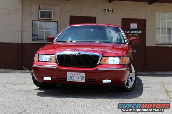 Red 2002 Mercury Grand Marquis front view, license plate reads EVIL MGM