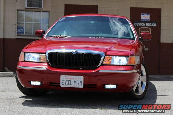 Red 2002 Mercury Grand Marquis front view with custom license plate "EVIL MGM"