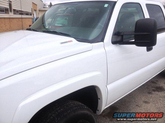 White pickup truck with Duramax Diesel badge on fender. Looks like a 2006 model