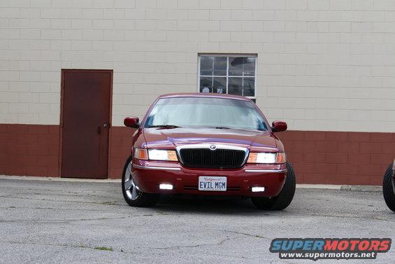 Red 2002 Mercury Grand Marquis front view with custom "EVIL MGM" license plate