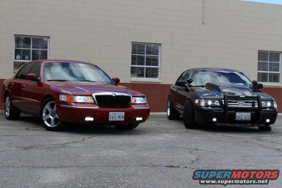 red Mercury Grand Marquis and black Ford Crown Victoria with push bar