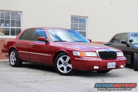 Red 2002 Mercury Grand Marquis with custom license plate 'EVIL MGM'
