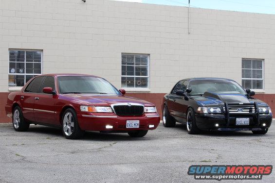 Red sedan and black modified sedan parked outside