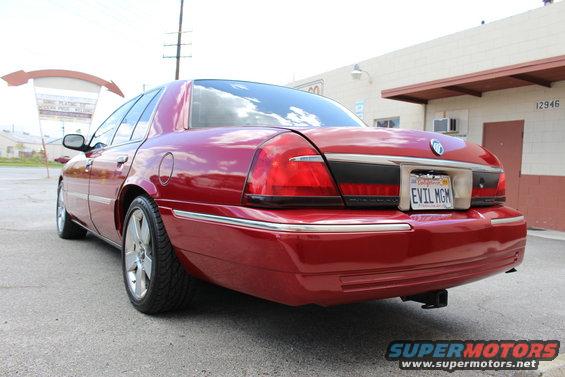 2002 Mercury Grand Marquis rear view, red paint, custom license plate 'EVIL MGM'