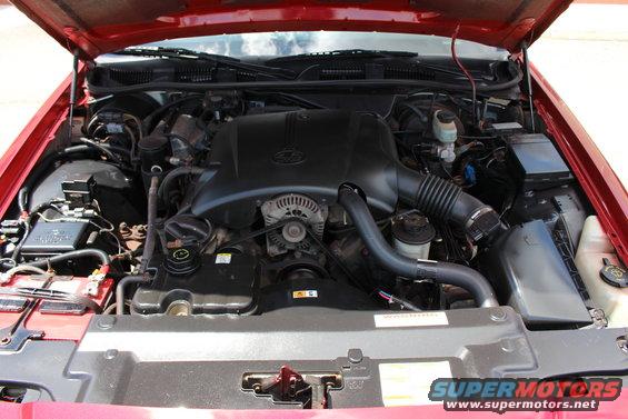 2002 Mercury Grand Marquis engine bay with red exterior paint visible