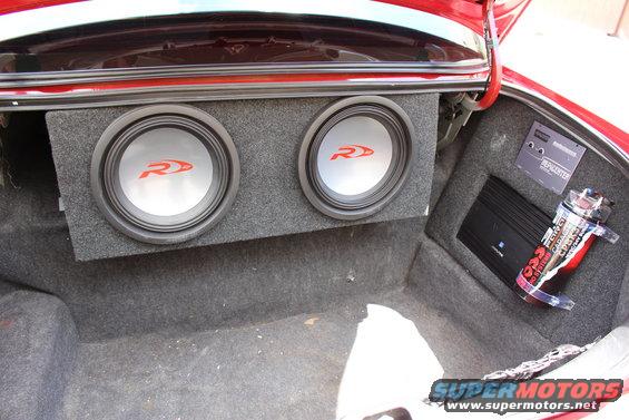 Trunk with dual Alpine subwoofers, amplifier, and capacitor