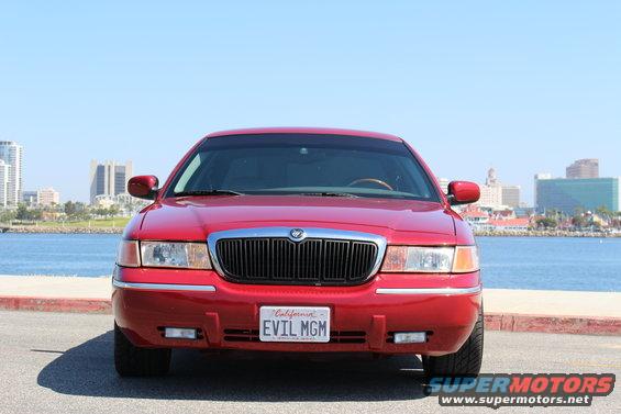Front view of a red Mercury Grand Marquis with a California license plate that reads EVIL MGM