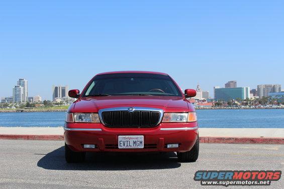 Red 2002 Mercury Grand Marquis parked by the water, front view