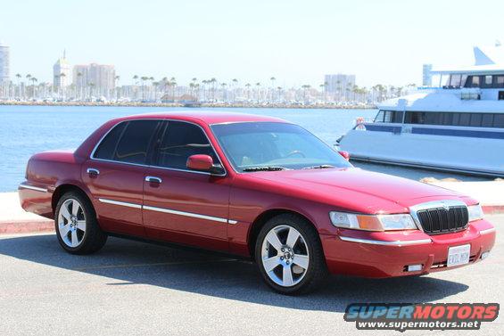 Red 2002 Mercury Grand Marquis parked by water