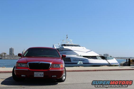 2002 Mercury Grand Marquis parked in front of the Starship Express yacht