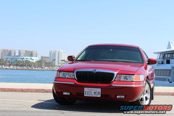 Red 2002 Mercury Grand Marquis with California plate "EVIL MGM" parked by the water
