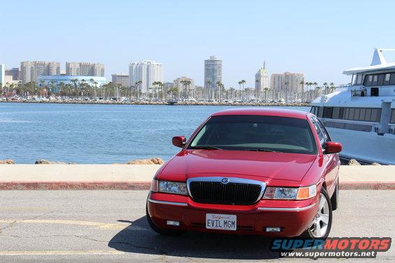 Red 2002 Mercury Grand Marquis front view with custom 'EVIL MGM' license plate
