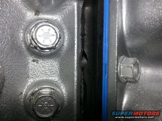 Close-up of engine bolts and blue gasket