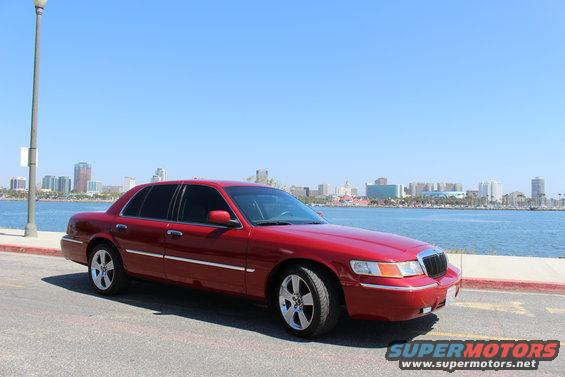 Red 2002 Mercury Grand Marquis parked by water