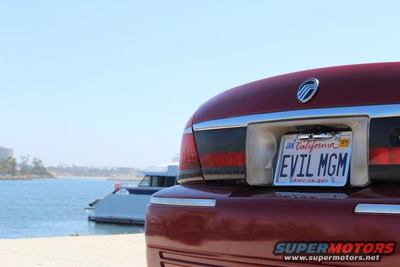 Red Mercury Grand Marquis rear with 'EVIL MGM' license plate