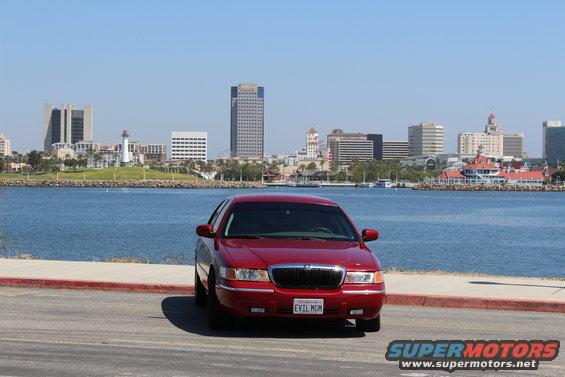 Red 2002 Mercury Grand Marquis front view with city skyline