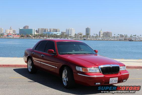 Red 2002 Mercury Grand Marquis with custom license plate 'EVIL MGM'