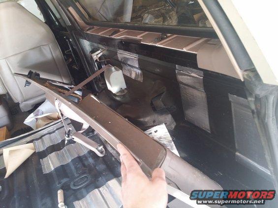 Interior of vehicle with soundproofing on rear panels and removed trim piece