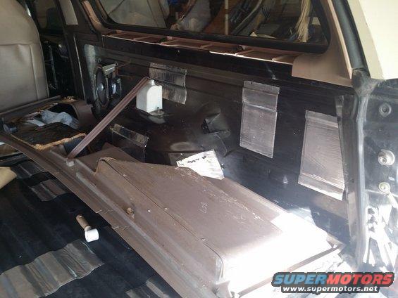 1994 Ford Bronco interior with soundproofing material applied to the rear panels and floor
