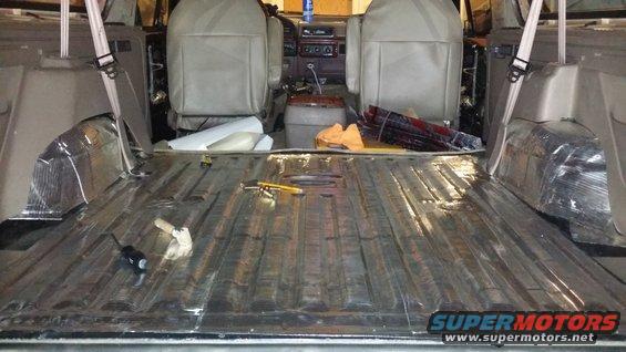 1994 Ford Bronco interior showing soundproofing on the floor and seats