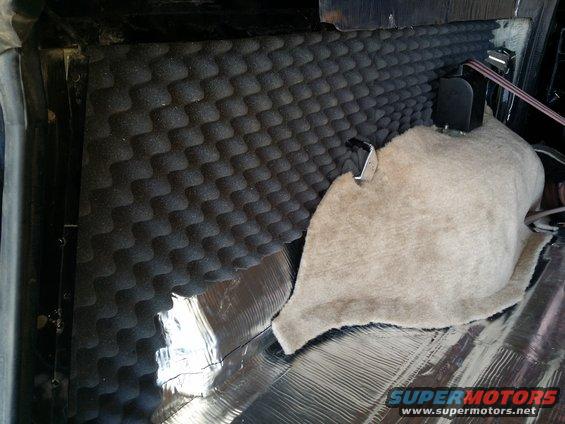 1994 Ford Bronco interior with soundproofing foam and carpet partially installed