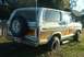 1979 Ford Bronco - This 1979 Ford Bronco features a classic white and wood-paneled exterior, with a spare tire prominently displayed on the rear.