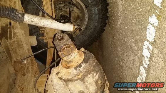 close-up of vehicle's driveshaft and suspension parts