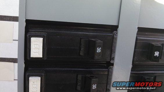Close-up of electrical breakers labeled '30' and 'TEST'