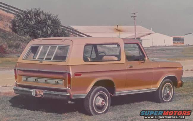 Tan Ford Bronco, rear 3/4 view. License plate reads 7M-376